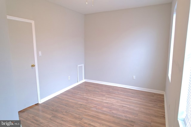 unfurnished room with dark hardwood / wood-style flooring