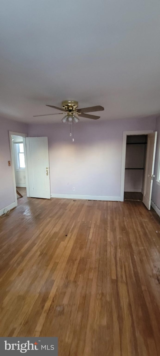 unfurnished living room with hardwood / wood-style flooring and ceiling fan