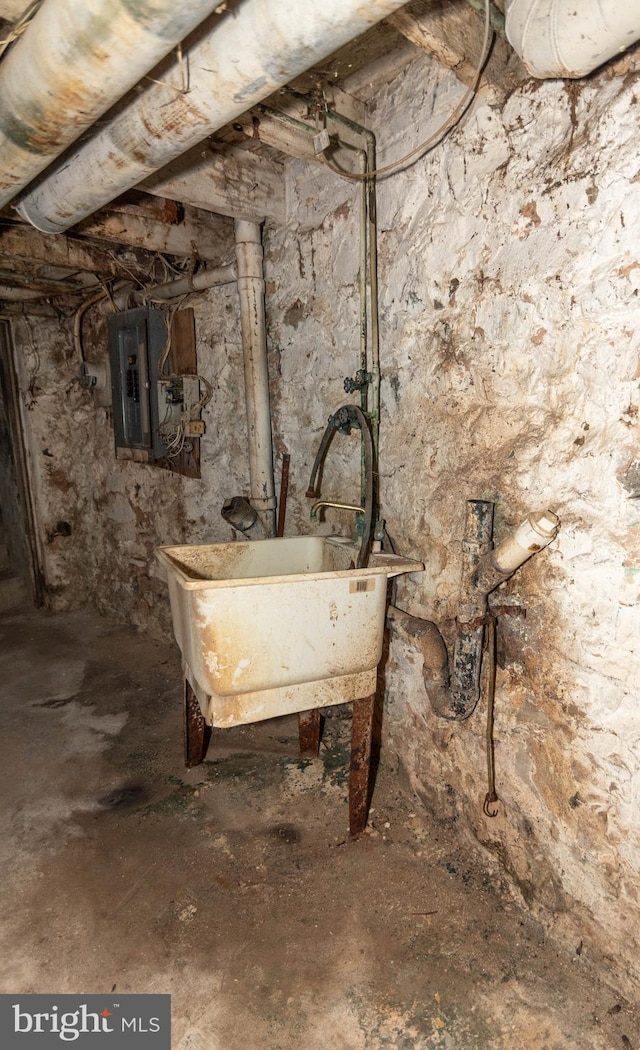 basement with sink and electric panel