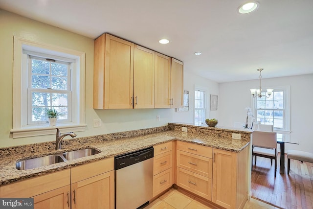 kitchen with a healthy amount of sunlight, light brown cabinets, dishwasher, a peninsula, and a sink