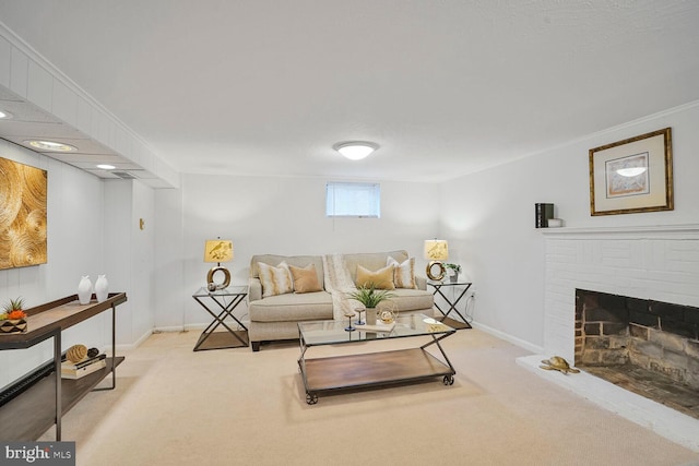 living area featuring baseboards, carpet, ornamental molding, and a fireplace