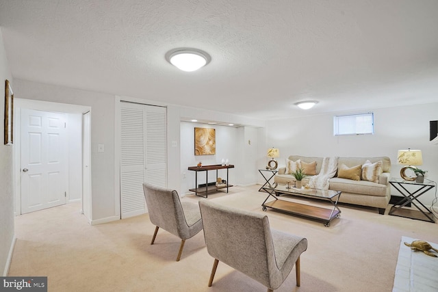 living room featuring light colored carpet and a textured ceiling