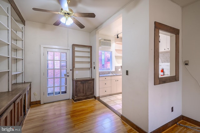 entryway featuring ceiling fan, sink, and light wood-type flooring