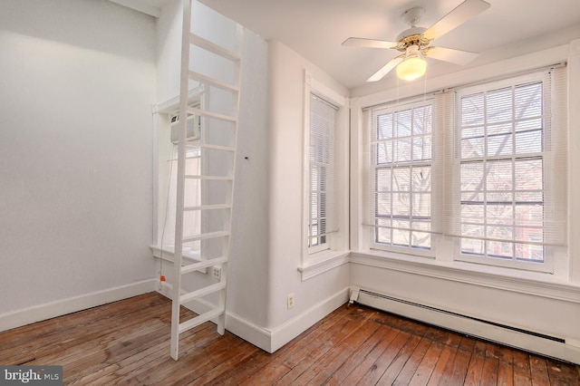 interior space with hardwood / wood-style flooring, ceiling fan, and baseboard heating