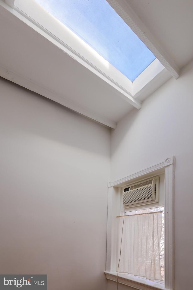 interior details featuring a skylight and a wall unit AC