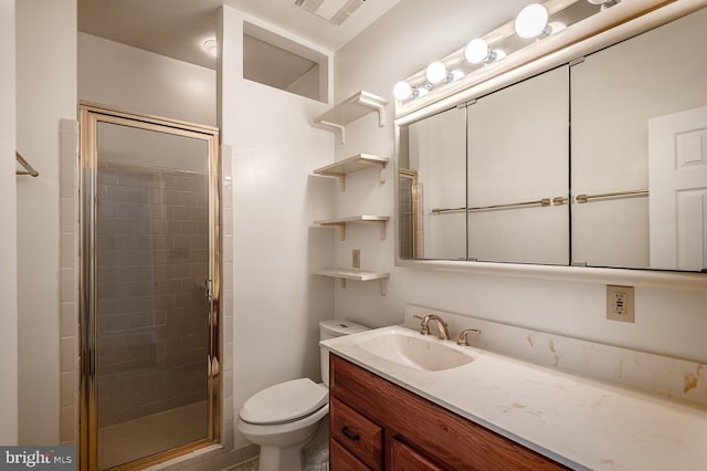 bathroom with a shower with door, vanity, and toilet