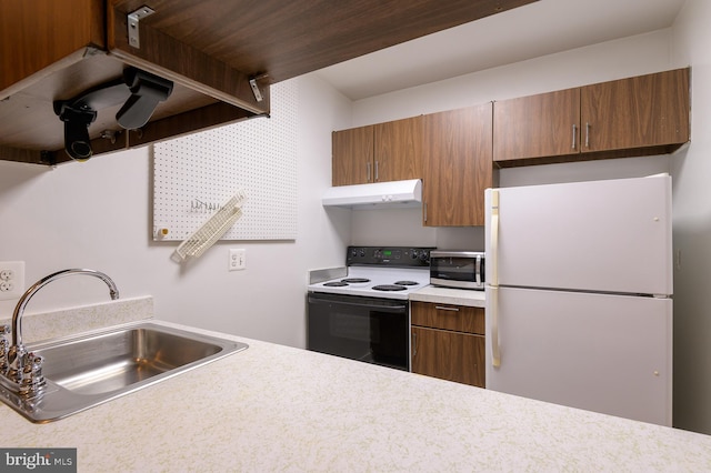 kitchen with range with electric cooktop, sink, and white fridge