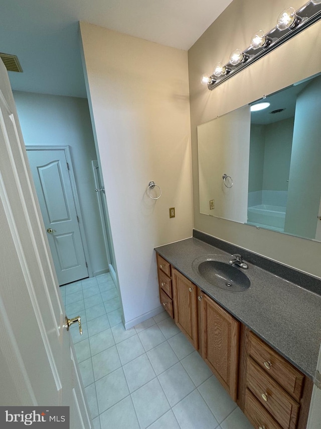 bathroom with tile patterned floors and vanity