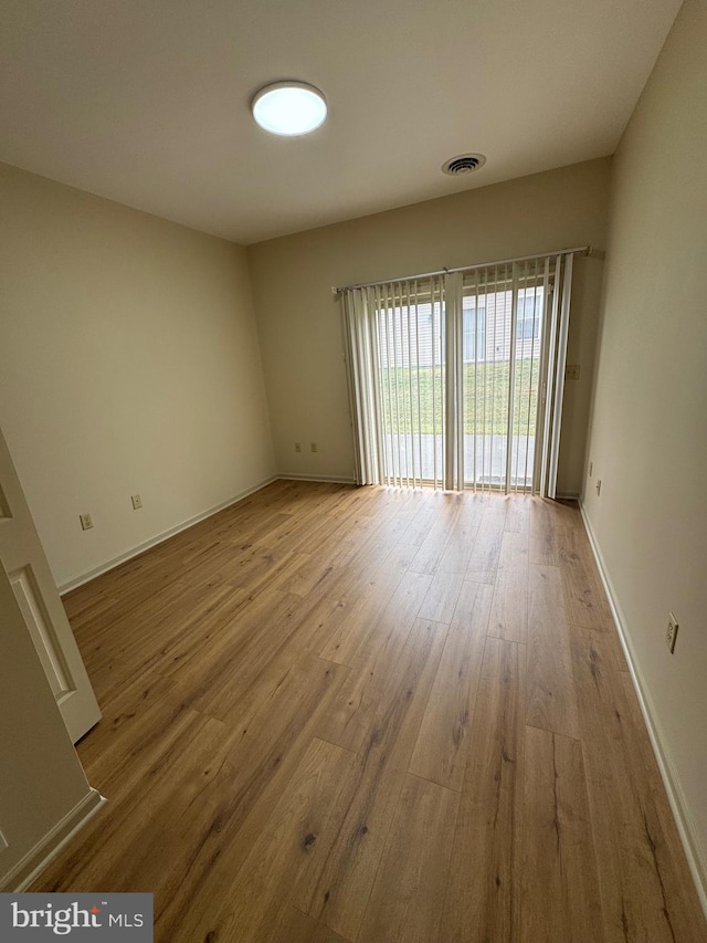 spare room with light hardwood / wood-style floors