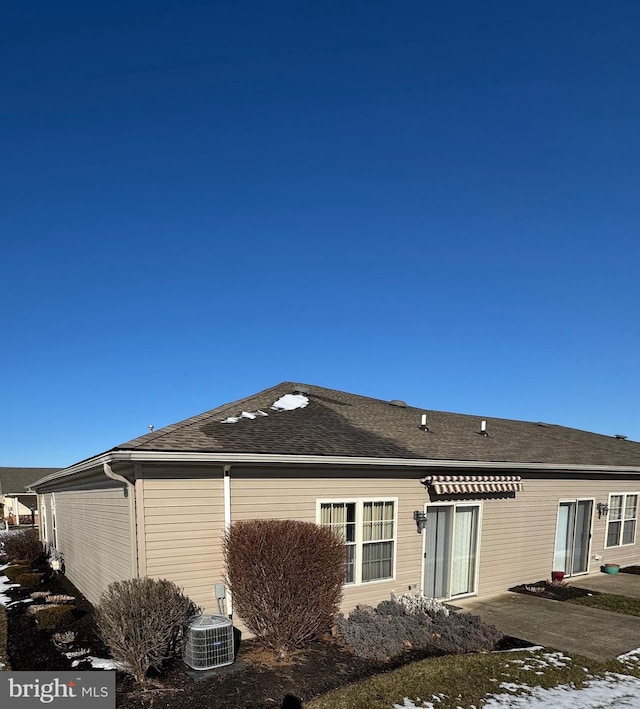 rear view of house featuring cooling unit