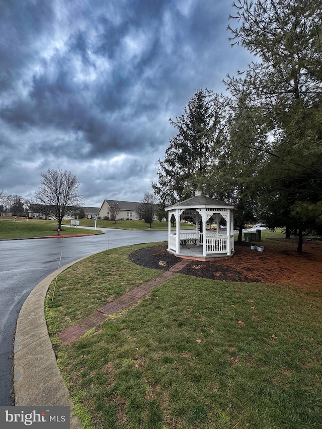 view of home's community with a gazebo and a yard