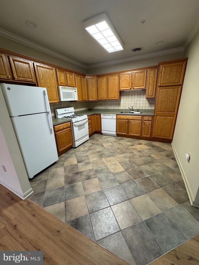 kitchen featuring white appliances, ornamental molding, sink, and decorative backsplash