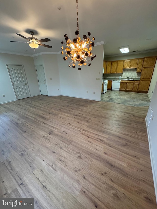 unfurnished dining area with crown molding, wood-type flooring, and ceiling fan with notable chandelier