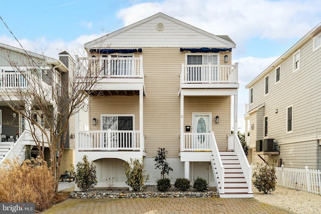 view of front facade with central AC and a balcony