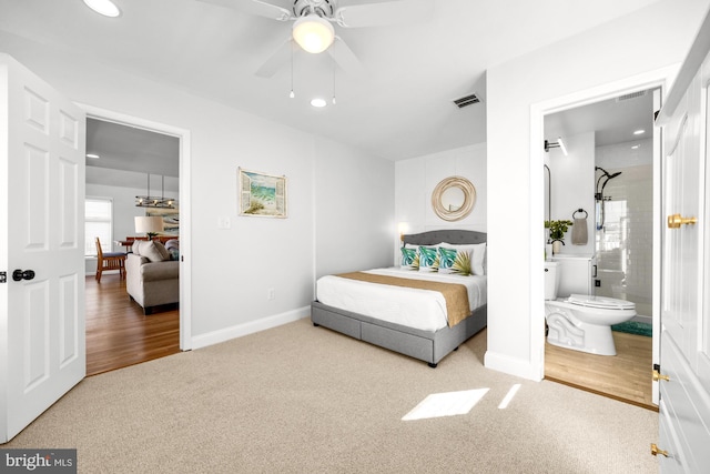 bedroom featuring ensuite bath, ceiling fan, and carpet flooring