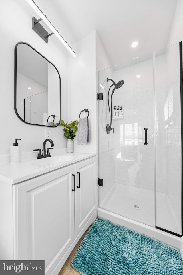 bathroom featuring vanity and an enclosed shower