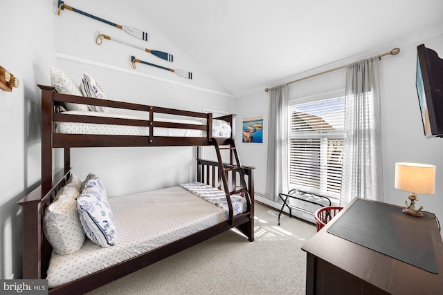 bedroom with lofted ceiling, light carpet, and a baseboard radiator