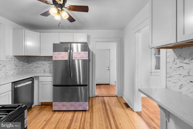 kitchen featuring white cabinetry, appliances with stainless steel finishes, decorative backsplash, and light wood-type flooring