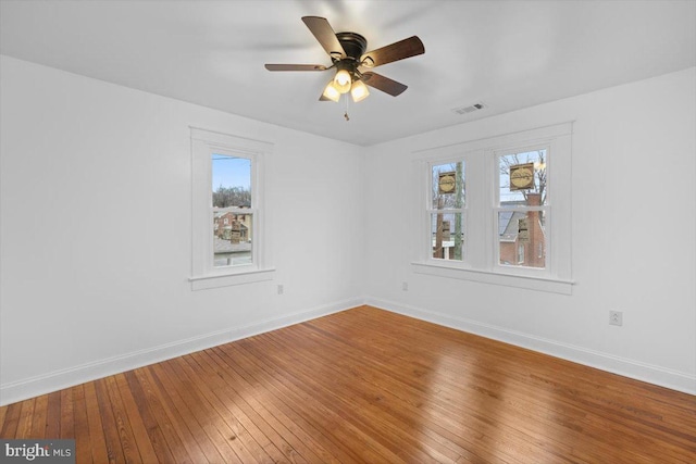 empty room with wood-type flooring and ceiling fan