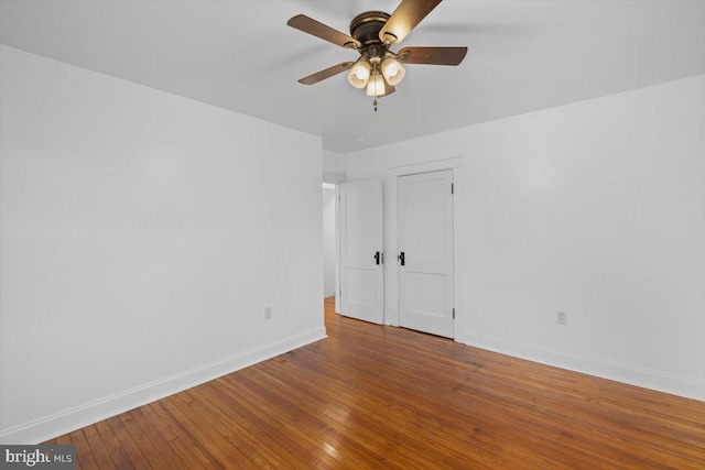 spare room featuring wood-type flooring and ceiling fan