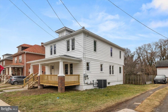 view of front facade with central AC unit and a front lawn