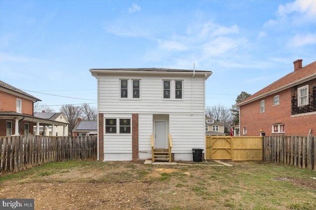 rear view of house featuring a lawn