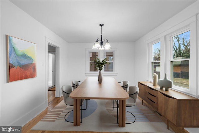 dining area featuring an inviting chandelier and light wood-type flooring