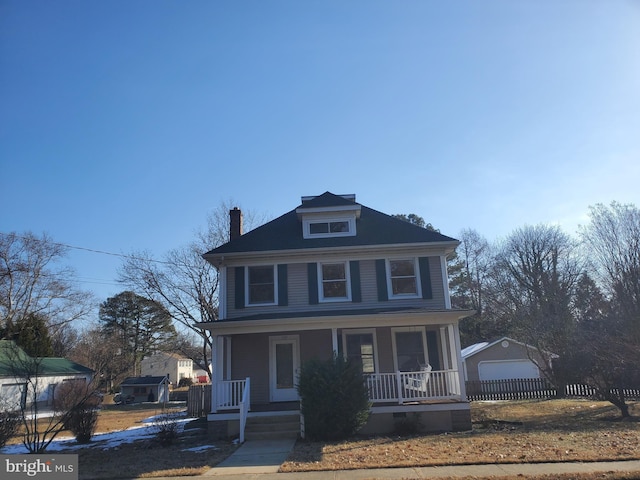 view of front property featuring a garage, an outdoor structure, and covered porch