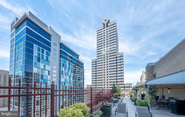 view of community with a patio area and a city view