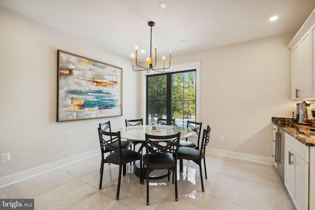 tiled dining room featuring an inviting chandelier