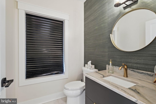 bathroom featuring vanity, toilet, and tile patterned flooring