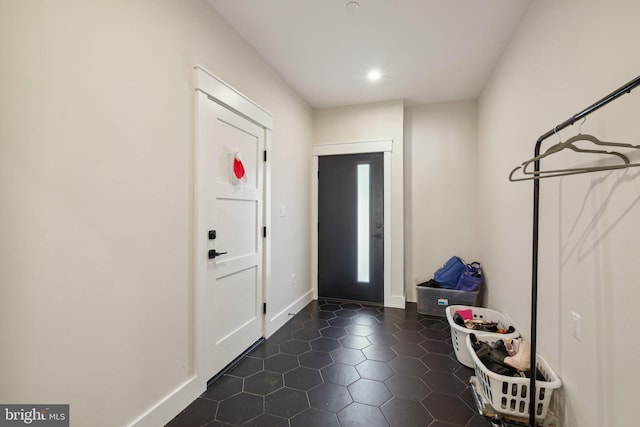 entryway featuring dark tile patterned floors