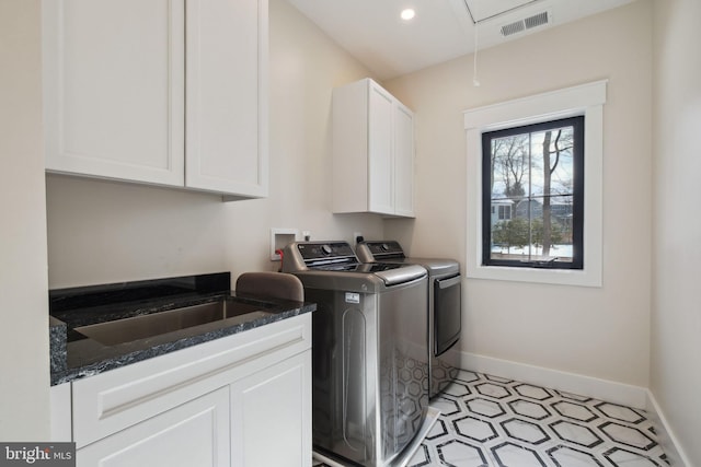 laundry area with sink, cabinets, and washing machine and clothes dryer