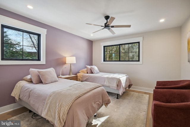 bedroom featuring ceiling fan and light hardwood / wood-style flooring