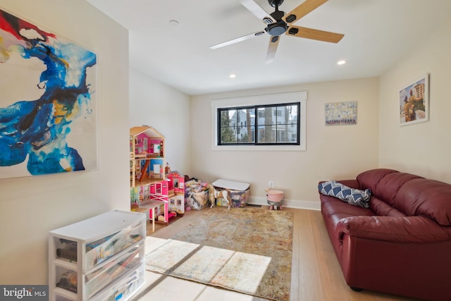 rec room featuring ceiling fan and light hardwood / wood-style floors