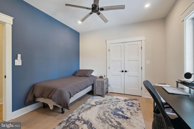 bedroom with ceiling fan and light hardwood / wood-style floors