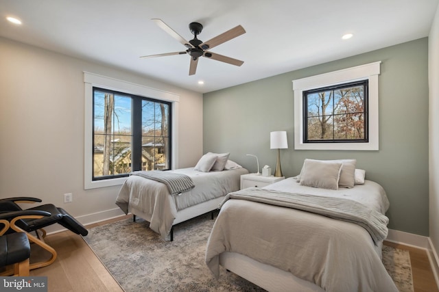 bedroom with ceiling fan and light hardwood / wood-style flooring