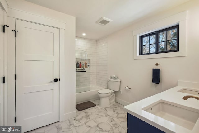 full bathroom featuring vanity, tiled shower / bath combo, and toilet