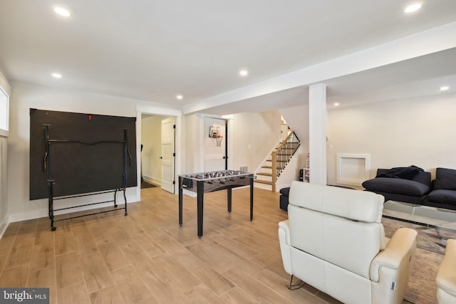 game room with light wood-type flooring