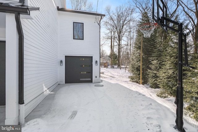 view of snow covered exterior with a garage