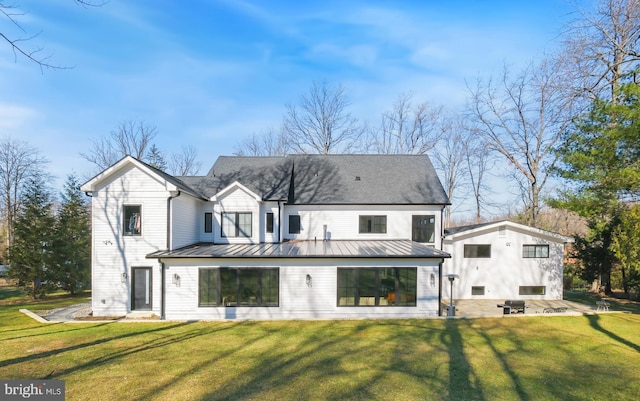 rear view of property with a yard