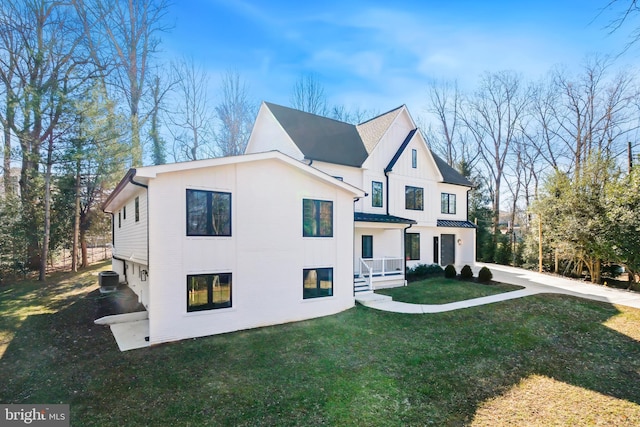 view of home's exterior featuring cooling unit and a lawn