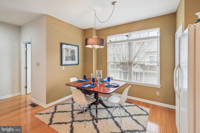 dining space with light wood-type flooring