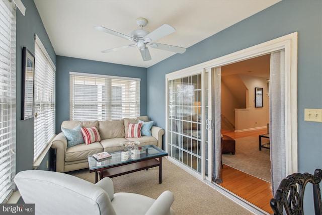 living room featuring ceiling fan and hardwood / wood-style floors