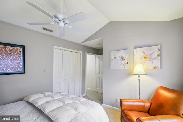 carpeted bedroom featuring lofted ceiling, ceiling fan, and a closet