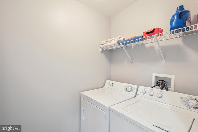 clothes washing area featuring separate washer and dryer