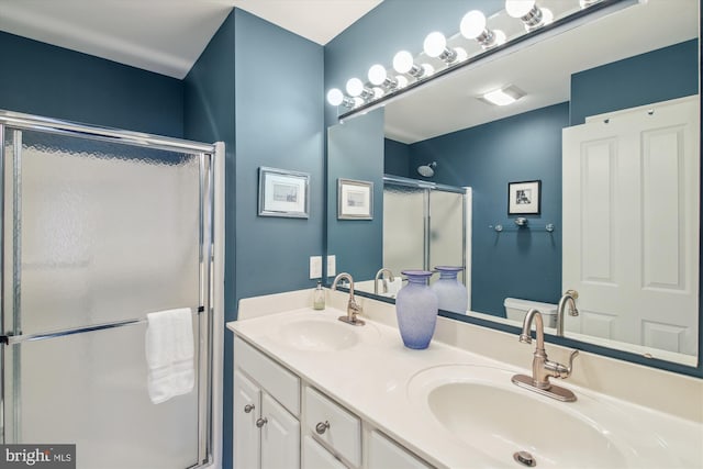 bathroom with an enclosed shower and vanity