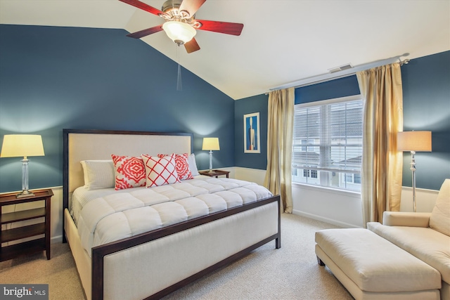 bedroom featuring vaulted ceiling, light colored carpet, and ceiling fan