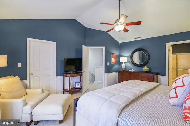 bedroom featuring ceiling fan, light colored carpet, and vaulted ceiling