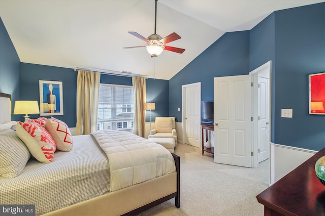 bedroom featuring light carpet, vaulted ceiling, and ceiling fan